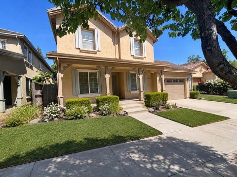 Single-family rental home exterior with front lawn